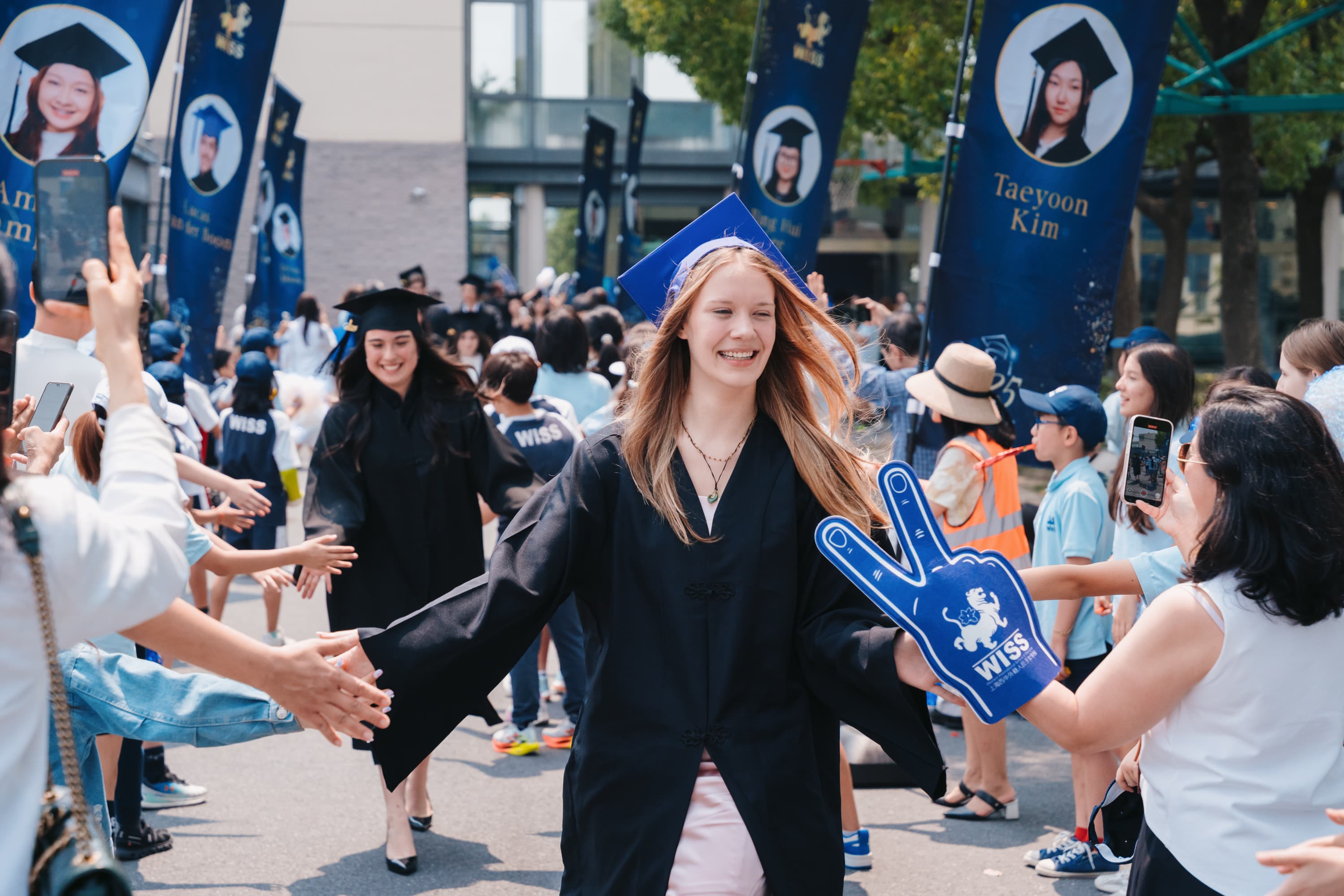 WISS graduate walking through celebratory guard of honor at graduation ceremony